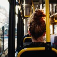 A female sitting in the bus captured from behind